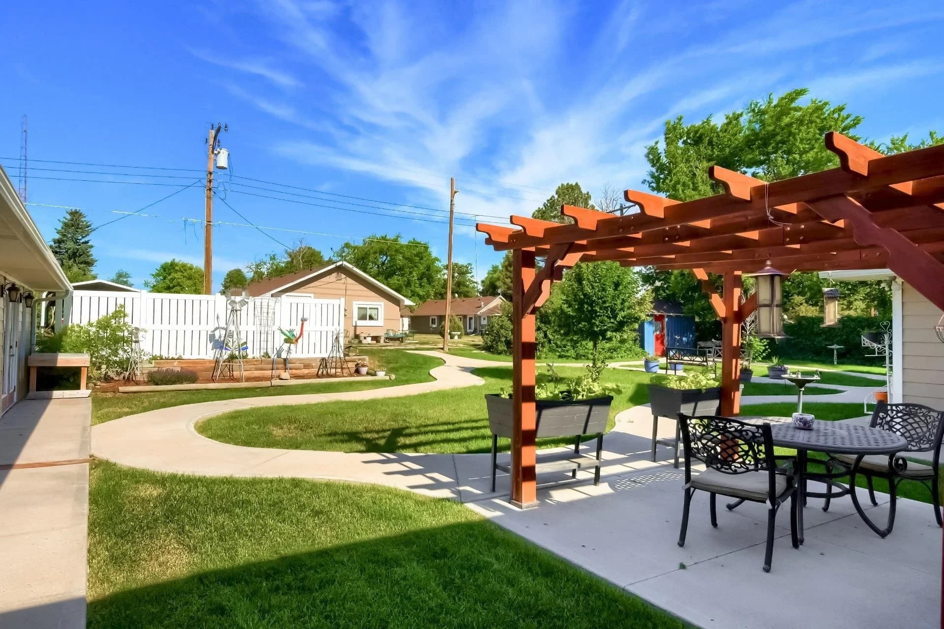 Landscaped backyard patio with pergola at an Aspen Leaf home